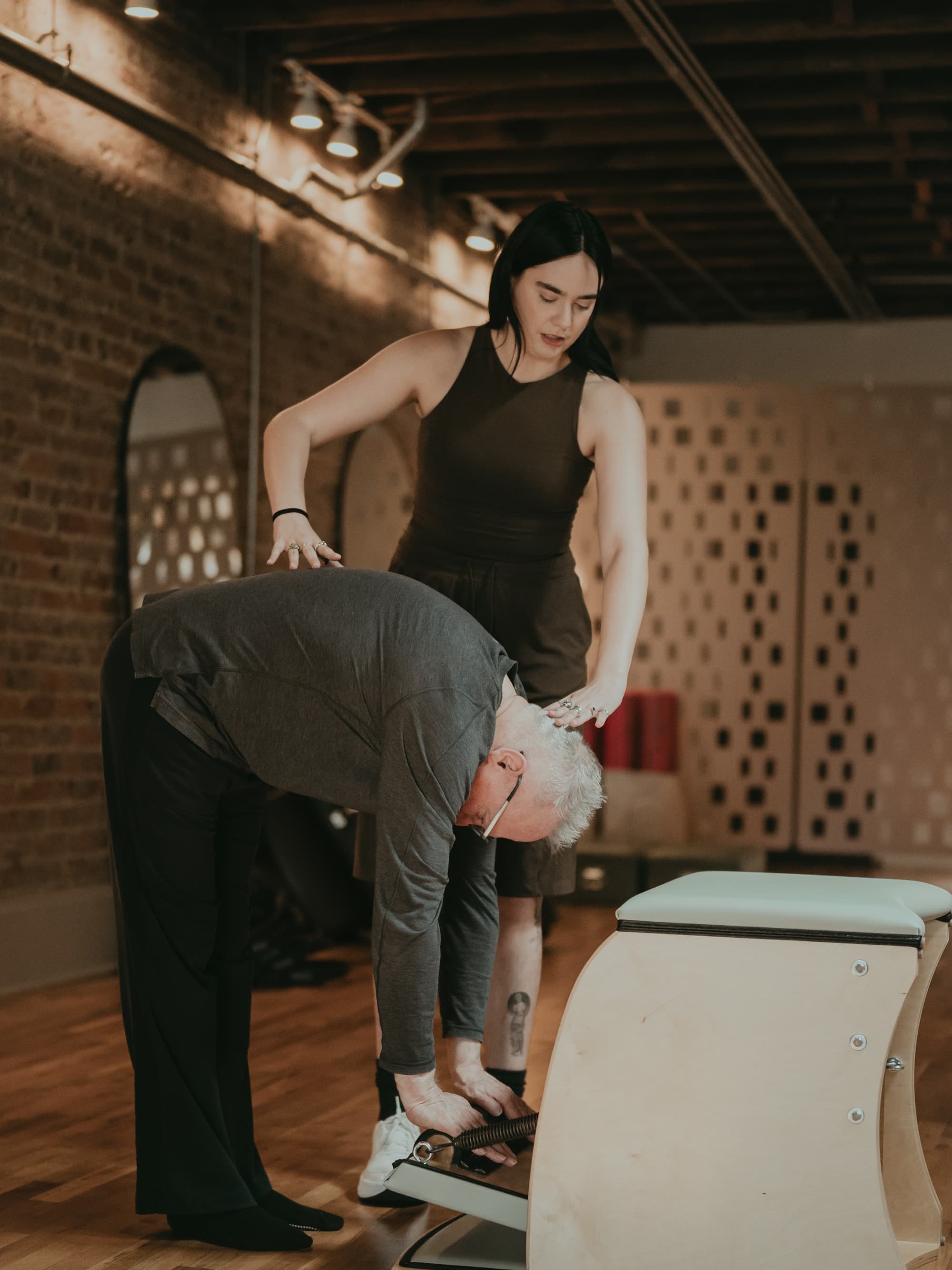 Hands-on coaching during a private Pilates session at Boomerang